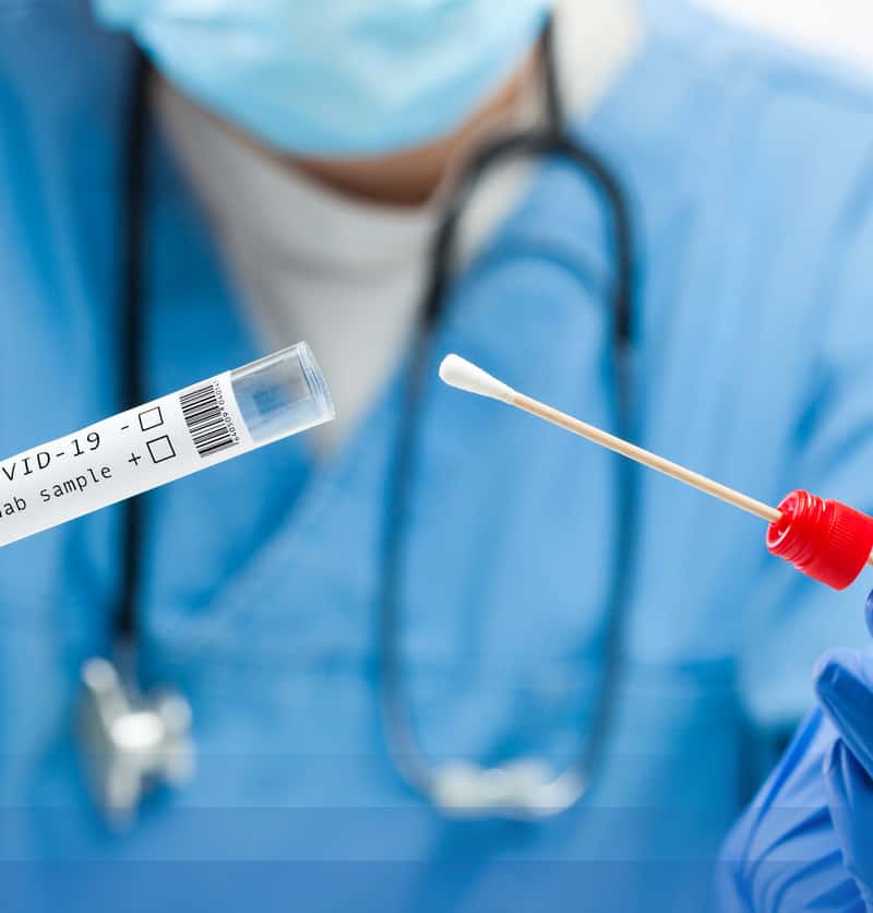 lab worker with swab sample for covid-19 test